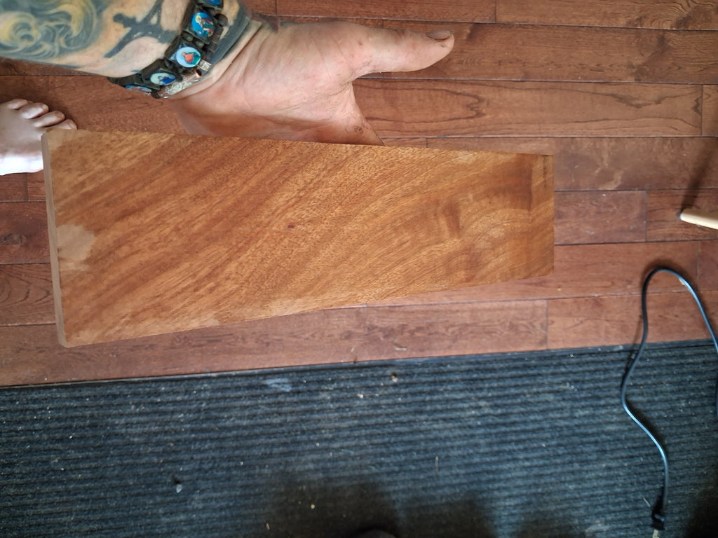 Exotic hardwood board showing rose, salmon and reddish-copper figure