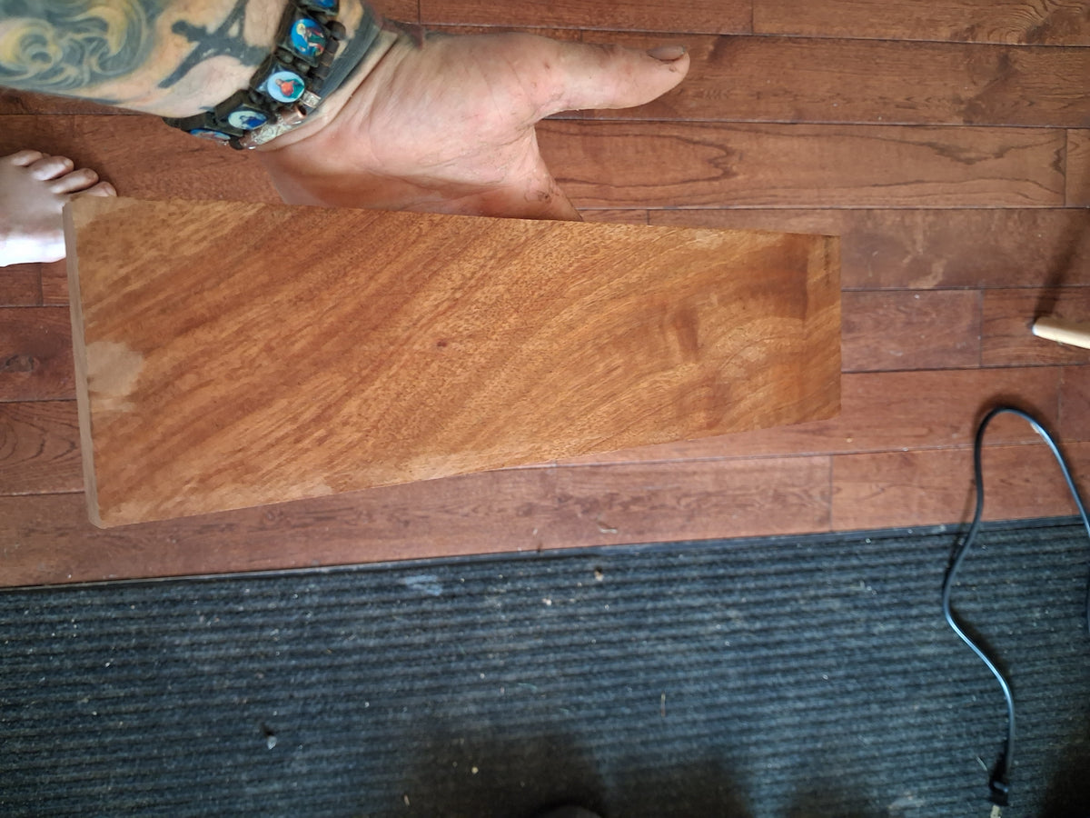 Exotic hardwood board showing rose, salmon and reddish-copper figure