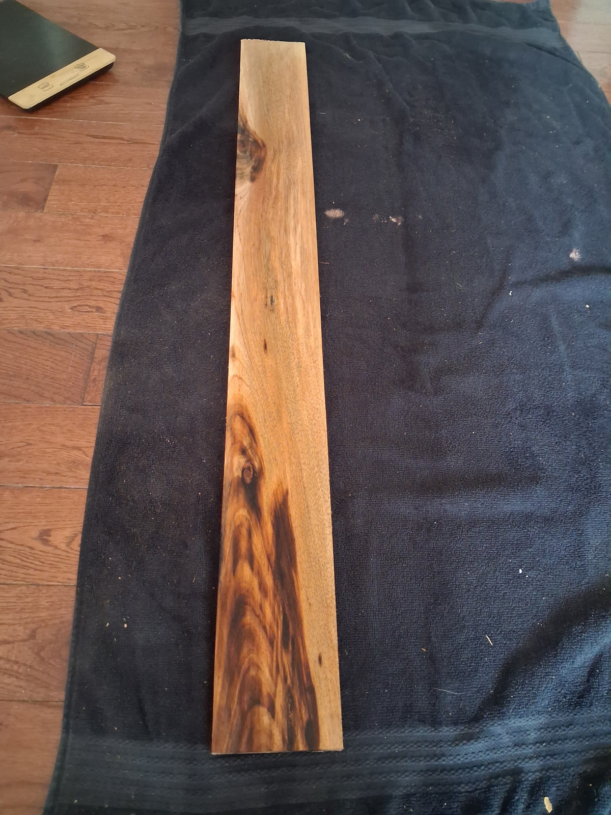 Figured Mahogany board with golden-brown color and dark natural figure